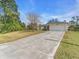 Charming single-story home features a well-manicured front yard and long driveway leading to an attached two-car garage at 1382 Ronald St, North Port, FL 34286