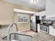 Well-lit kitchen featuring stainless steel appliances and granite countertops at 1382 Ronald St, North Port, FL 34286