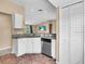 Modern kitchen featuring granite countertops, stainless steel appliances, and white cabinets at 1382 Ronald St, North Port, FL 34286