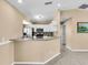Spacious kitchen featuring stainless steel appliances, white cabinets, and granite counters at 1382 Ronald St, North Port, FL 34286