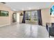 Bright living room featuring neutral paint, gray tile flooring, and large windows with views at 1382 Ronald St, North Port, FL 34286
