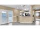 Open living space features modern kitchen with stainless appliances and tile floors at 1382 Ronald St, North Port, FL 34286