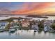 Sunset aerial view of homes on the water, with boat docks and amazing landscaping at 1389 Tangier Way, Sarasota, FL 34239