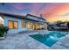Expansive backyard featuring a sparkling pool, spa, and beautiful architecture with great lighting and spacious patio at 1389 Tangier Way, Sarasota, FL 34239