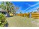 Backyard featuring newly installed fence, grass, and a small tree at 2299 Riverwood Ct, Sarasota, FL 34231