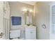 Well-lit bathroom featuring a modern vanity, mirror, and decorative nautical accents at 2299 Riverwood Ct, Sarasota, FL 34231