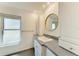 Bathroom with a sink, mirror, and window offering natural light at 2299 Riverwood Ct, Sarasota, FL 34231