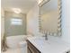 Bathroom with a bathtub, modern fixtures, and a well-lit vanity area at 2299 Riverwood Ct, Sarasota, FL 34231