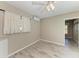 Bright bedroom featuring neutral walls, wood-look tile flooring, and a ceiling fan with light fixture at 2299 Riverwood Ct, Sarasota, FL 34231