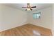Simple bedroom with hardwood floors, ceiling fan and natural light from a window at 2299 Riverwood Ct, Sarasota, FL 34231