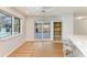 Breakfast nook with hardwood flooring, bright windows, and backyard pool views at 2299 Riverwood Ct, Sarasota, FL 34231
