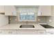 Updated kitchen with white cabinets, granite counters and stainless sink at 2299 Riverwood Ct, Sarasota, FL 34231