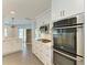 Bright kitchen features stainless steel appliances, white cabinets, tile backsplash, and marble countertop at 2299 Riverwood Ct, Sarasota, FL 34231