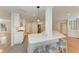 Modern, bright kitchen with an expansive quartz island and stainless steel appliances at 2299 Riverwood Ct, Sarasota, FL 34231