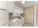 Updated kitchen with white cabinets and stainless steel appliances at 2299 Riverwood Ct, Sarasota, FL 34231
