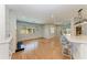 Open floor plan with hardwood floors flows from the living room to kitchen with fireplace at 2299 Riverwood Ct, Sarasota, FL 34231