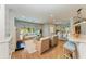Open living room with hardwood floors, natural light, and comfortable wicker furnishings at 2299 Riverwood Ct, Sarasota, FL 34231