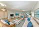 Comfortable living room with hardwood floors, wicker furniture, and a view to the patio at 2299 Riverwood Ct, Sarasota, FL 34231
