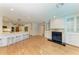 Spacious living room and eat-in kitchen with fireplace, barstool seating, and hardwood floors at 2299 Riverwood Ct, Sarasota, FL 34231
