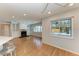 Open living room with fireplace, hardwood floors, and custom built-in cabinets at 2299 Riverwood Ct, Sarasota, FL 34231