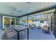 Covered patio with dining and lounge furniture, overlooking a private pool at 2299 Riverwood Ct, Sarasota, FL 34231