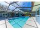 Beautiful pool with screen enclosure steps, and patio at 2299 Riverwood Ct, Sarasota, FL 34231