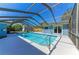 An exterior shot showcasing a beautiful pool with an enclosing screen at 2299 Riverwood Ct, Sarasota, FL 34231