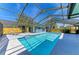 Exterior pool with screen, chairs, and sunny skies at 2299 Riverwood Ct, Sarasota, FL 34231