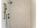 Modern tiled shower with brushed bronze fixtures and hand shower at 2299 Riverwood Ct, Sarasota, FL 34231