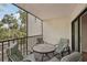Balcony with seating area overlooking tropical views at 2753 Orchid Oaks Dr # 104, Sarasota, FL 34239
