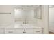 Bright bathroom featuring vanity with solid surface countertop and large mirror at 2753 Orchid Oaks Dr # 104, Sarasota, FL 34239