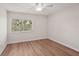 Bedroom with wood floors and a window at 2753 Orchid Oaks Dr # 104, Sarasota, FL 34239