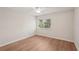 Cozy bedroom with light-colored floors and a bright window at 2753 Orchid Oaks Dr # 104, Sarasota, FL 34239