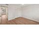 Clean bedroom featuring wood flooring and a closet with folding doors at 2753 Orchid Oaks Dr # 104, Sarasota, FL 34239