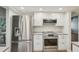 Modern kitchen featuring stainless steel appliances, white cabinetry, and ample counter space at 2753 Orchid Oaks Dr # 104, Sarasota, FL 34239