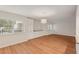 Bright living room with hardwood floors, custom built-ins, and large windows at 2753 Orchid Oaks Dr # 104, Sarasota, FL 34239