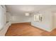 Spacious living room featuring wood floors, modern lighting, and a view into the kitchen at 2753 Orchid Oaks Dr # 104, Sarasota, FL 34239