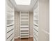 Walk-in closet with custom shelving and drawers for storage at 2753 Orchid Oaks Dr # 104, Sarasota, FL 34239