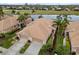 Aerial view of a home featuring a tile roof and a beautiful lakeside backyard with golf course views at 288 Fairway Isles Ln, Bradenton, FL 34212