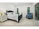 Serene bedroom features a plush bed, stylish bedside table, and view to tropical outdoors at 3178 Dick Wilson Dr, Sarasota, FL 34240