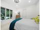Bright bedroom with a large window, comfortable bed, and neutral tones, creating a peaceful and inviting atmosphere at 3178 Dick Wilson Dr, Sarasota, FL 34240
