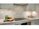 Modern kitchen features a sleek cooktop, stylish backsplash, and ample counter space at 3178 Dick Wilson Dr, Sarasota, FL 34240