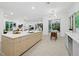 Open-concept kitchen with large island, sleek countertops, and seamless flow to living areas at 3178 Dick Wilson Dr, Sarasota, FL 34240