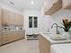 Well-organized laundry room featuring plenty of storage, a sink, and modern appliances for convenient chores at 3178 Dick Wilson Dr, Sarasota, FL 34240