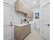 Efficient laundry room with ample cabinet space, modern sink, and appliances, offering practicality and style at 3178 Dick Wilson Dr, Sarasota, FL 34240