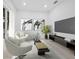 Modern living room with sleek furniture, contemporary art, and a large screen TV for stylish and comfortable living at 3178 Dick Wilson Dr, Sarasota, FL 34240