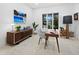 Bright office space with modern desk, sleek storage cabinet, and large window views at 3178 Dick Wilson Dr, Sarasota, FL 34240