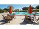 Community lap pool with tables and umbrellas for relaxing by the poolside at 3178 Dick Wilson Dr, Sarasota, FL 34240