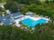 Aerial shot of a community pool surrounded by lush greenery and ample seating at 3178 Dick Wilson Dr, Sarasota, FL 34240