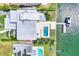 Aerial view of stunning waterfront property featuring a pool, boat dock, and lush landscaping at 3638 San Remo Ter, Sarasota, FL 34239